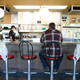 A man sits at a Waffle House counter surrounded by seats bagged up for social distancing purposes